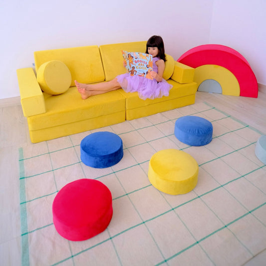 Child reading on the colorful FUDGee play sofa