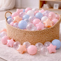 Pastel and neutral colored baby ball pit balls with pear and transparent stars.